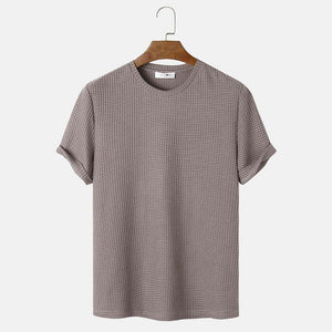 Men's summer solid color round neck t-shirt in beige on hanger.