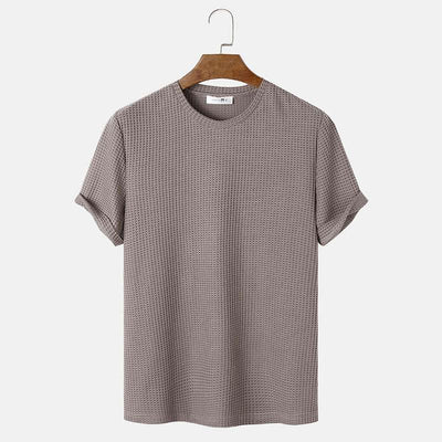 Men's summer solid color round neck t-shirt in beige on hanger.