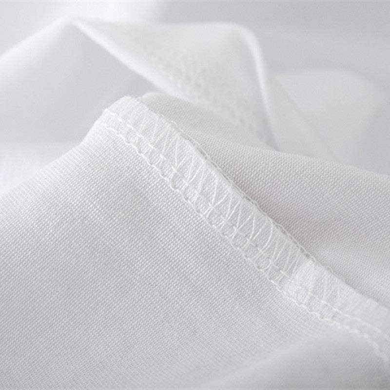 Close-up of white modal fabric stitching on a T-shirt.