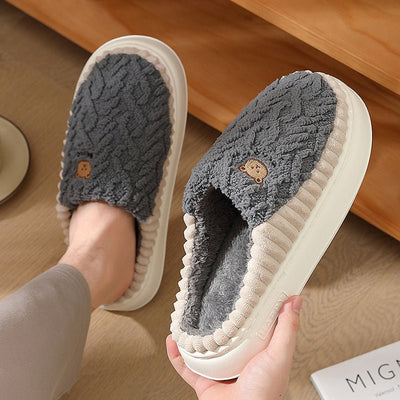 Cute bear plush slippers with warm fleece for indoor use.